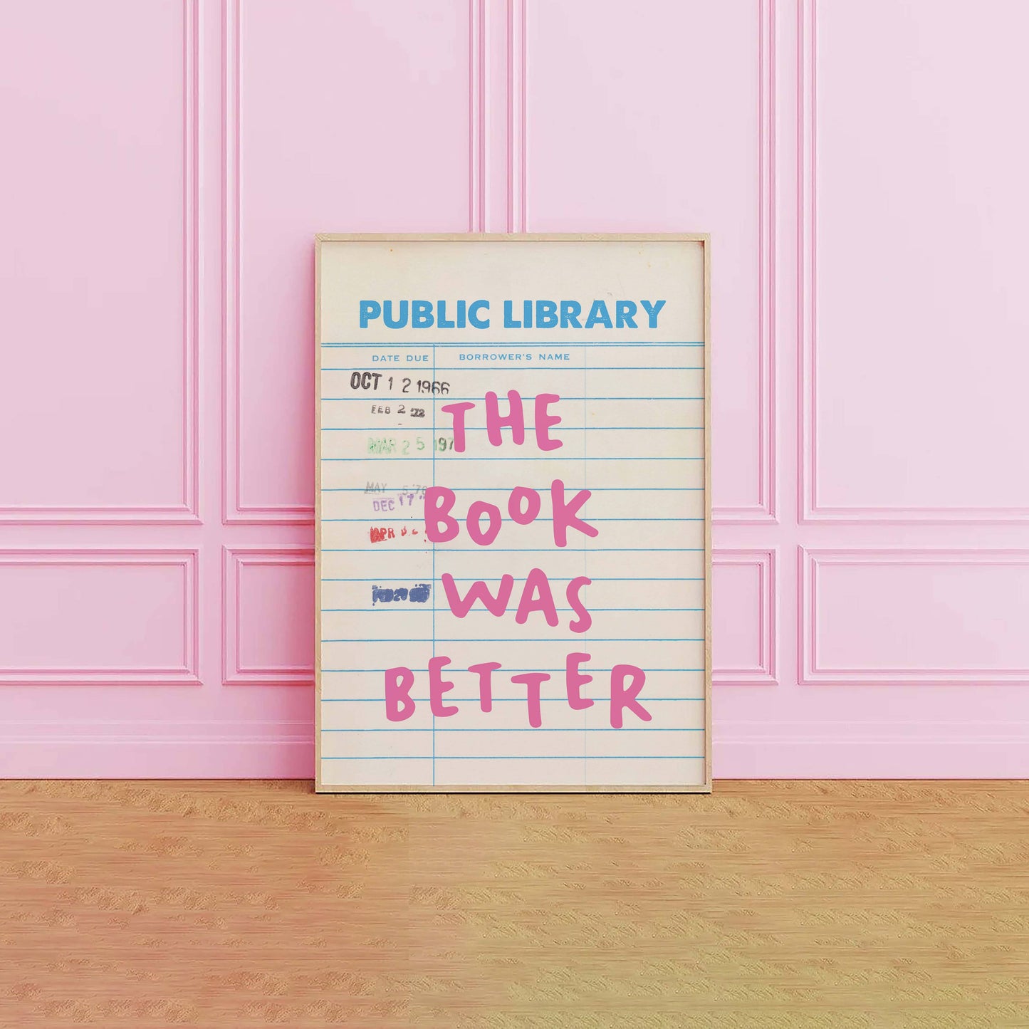 Framed poster with 'The Book Was Better' text on a pink wall.