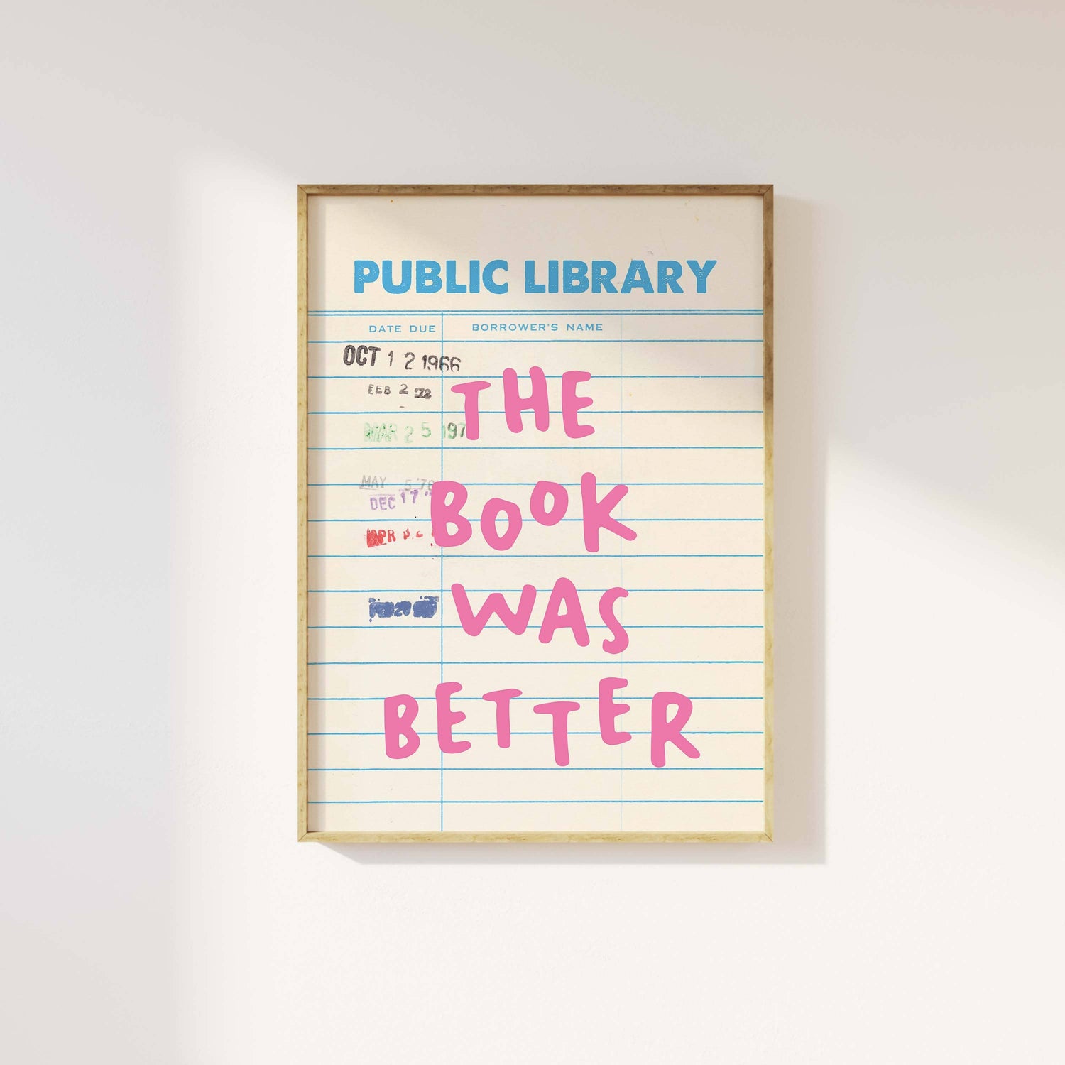 Framed print of a library card with 'The book was better' text on a white background