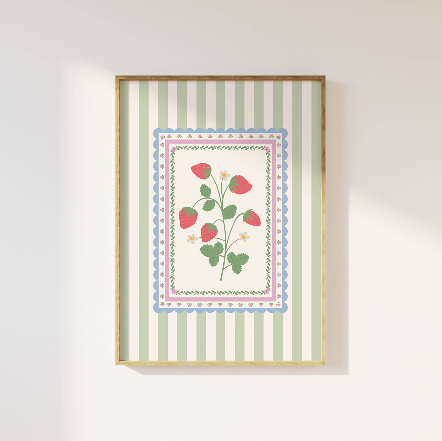 Framed artwork with strawberry floral design and striped background on a white wall