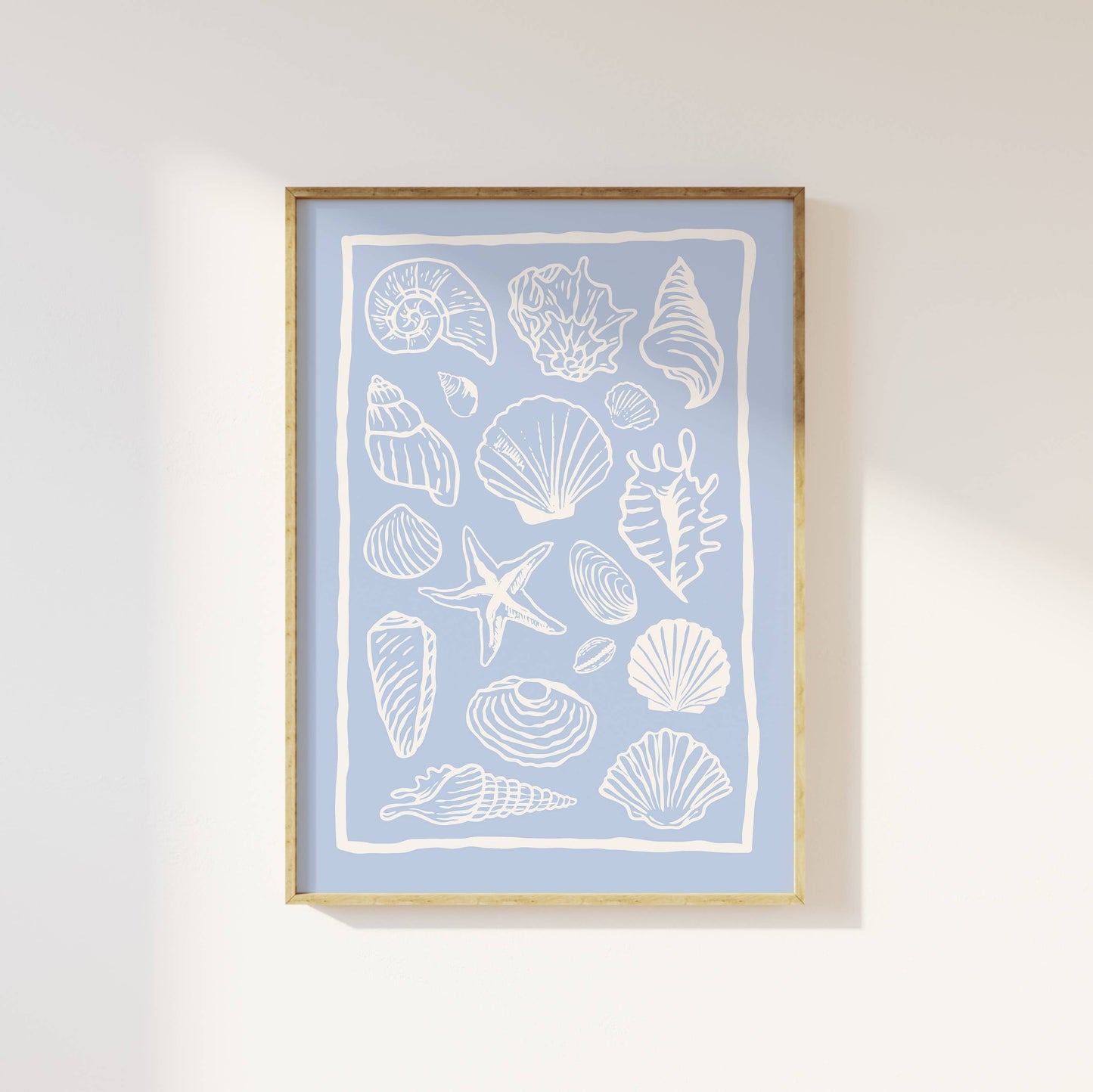 Framed artwork with white shell and starfish illustrations on a light blue background