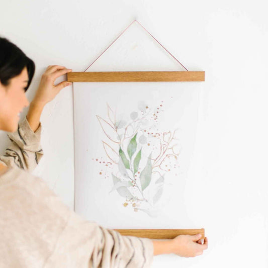 Hanging on a nail is our Hanger Frame. Hanging from a cord, 2 pieces of wood use magnets to hold the top of a print, two pieces of wood magnet to the bottom of the print.